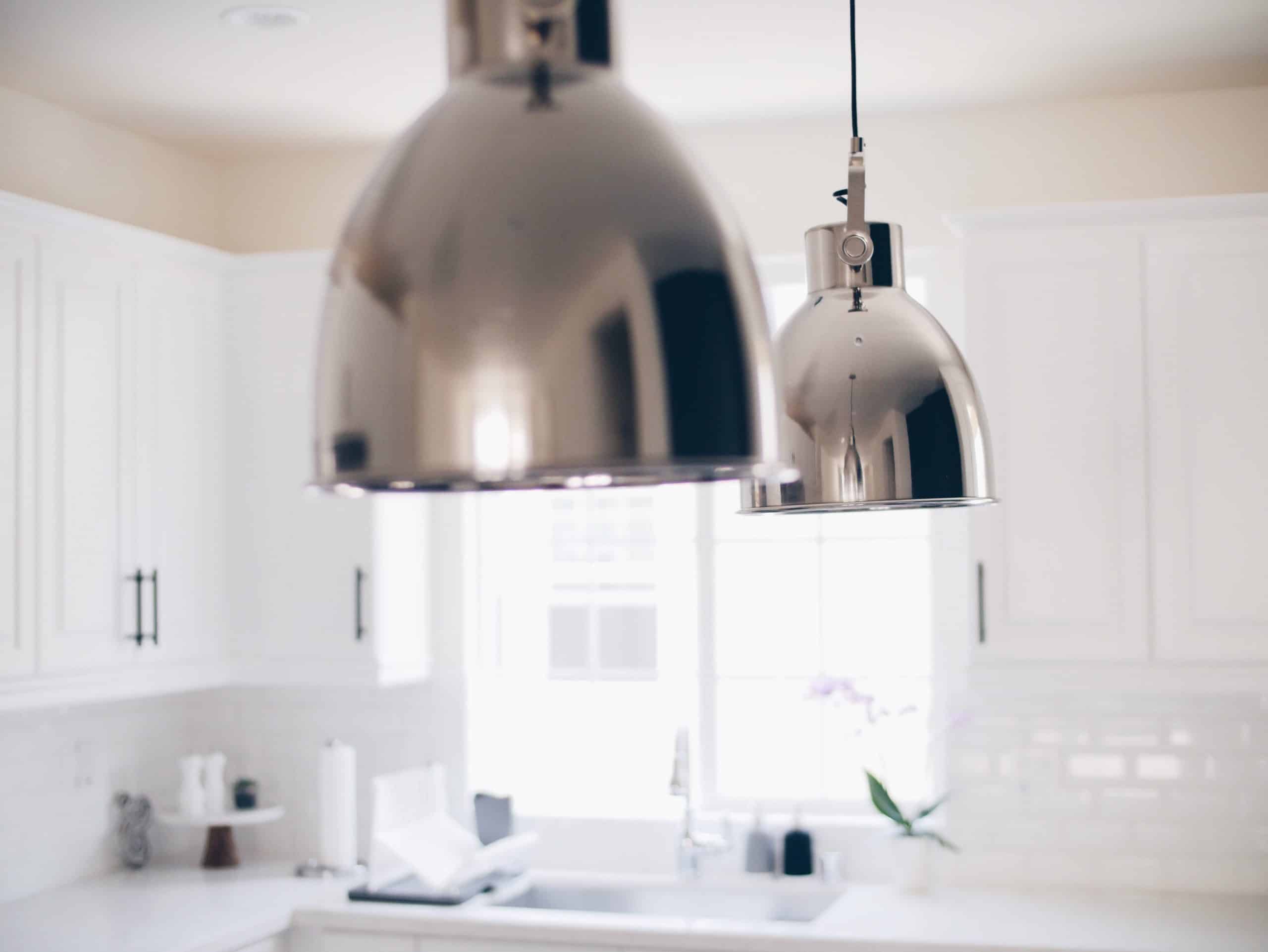 Bright and stylish pendant lights over a kitchen island, setup by PowerMaster Electrics